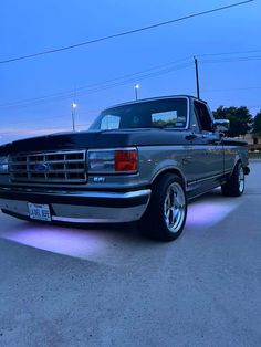 a truck parked in a parking lot with its lights on and the tail light turned on