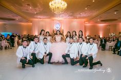 the bride and grooms pose for a photo in front of their guests at a wedding