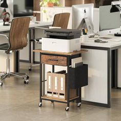 an office with two desks and one computer on top of the desk is shown