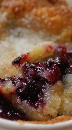 a close up of a plate of food with fruit on it and a fork in the bowl