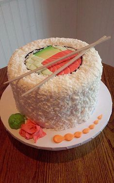 a cake with chopsticks sticking out of it