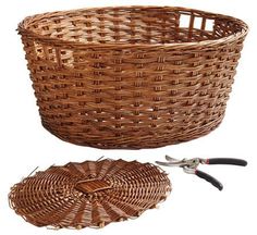 a wicker basket with scissors next to it on a white background and another item in the foreground