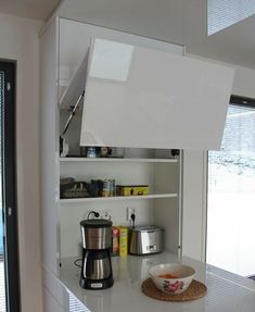 a kitchen counter with a coffee maker and other items on it