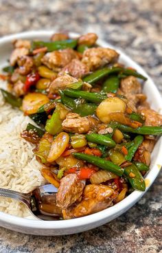 a white bowl filled with rice and vegetables