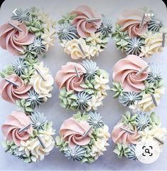 cupcakes decorated with pink and white frosting are arranged in a circle on a table