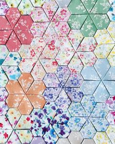 the colorful hexagons are made up of different colors and sizes, with flowers on them