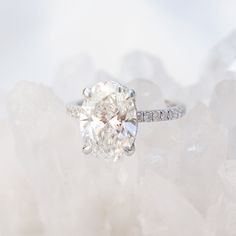 a diamond ring sitting on top of some white rocks