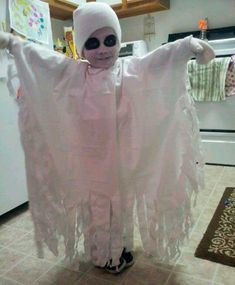 a person in a ghost costume standing on the floor