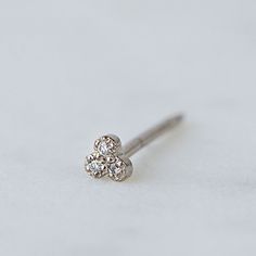 Please note this is for one earring, to order a pair, add two at checkout. SINGLE STUDS made to mix and match. Tiny trio studs bead set with G/VS diamonds. Earrings measure 3.1 mm Weight 0.3g (approximately) Elegant Diamond Nose Studs As Gift, Elegant Diamond Nose Studs For Gift, Elegant Tiny Round Nose Studs, Diamonds Earrings, One Earring, Vs Diamond, Bead Set, Instagram Icons, Mix And Match