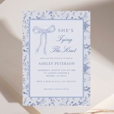 a blue and white card with a bow on it