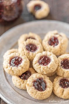 almond flour shortbread cookies on a plate with jam in the middle and text overlay reading almond flour shortbread cookies