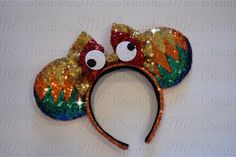 a close up of a mickey mouse ears headband with sequins and eyes