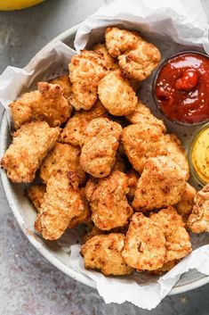 chicken nuggets with ketchup and mustard in a bowl