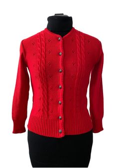 a red cardigan sweater on a mannequin