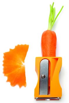 an orange carrot is being cut into pieces with a scissor on the side