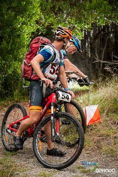 a man riding a bike down a dirt road