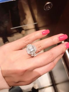 a close up of a person's hand with a ring on it