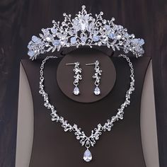 a tiara and earrings are on display