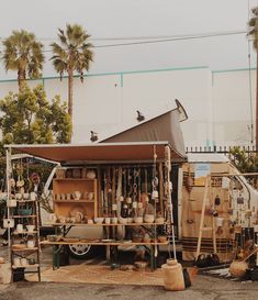 an old truck is parked in front of a building with lots of items on it