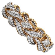 This Intricate yet Sparkly Piece is crafted in solid 18-karat Yellow & White Gold, weighing 83.7 Grams and measuring 6 ½” around the wrist x 18mm wide. Composed of a braided design of 18K Yellow Gold & elongated cluster design textured white gold links, and pave-set with 268 round-cut diamonds, weighing approximately 23.10 carats, graded G-H color and VS clarity. Secures with an Invisible insert clasp, Stamped with purity mark. In Excellent condition, This purchase is accompanied by a profession Emerald Diamond Earrings, Diamond Sapphire Engagement Ring, Sapphire Diamond Engagement, Marquise Diamond Engagement Ring, Emerald Cut Diamond Engagement, Cluster Design, Marquise Shape Diamond, Art Deco Bracelet, Bracelets Gold Diamond