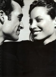 black and white photograph of two people looking at each other with smiles on their faces