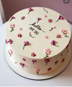 a white cake with pink flowers on it