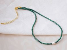 Green stone necklace is pretty and dainty. In this gold-plated beaded necklace, I have paired small malachite stone beads with a small genuine irregular-shape baroque freshwater pearl. Light-weight cute necklace, that you can easily wear every day, throughout the year.  The length of the necklace is 15 inches (38 cm), with a 2 inches (5 cm) extension chain - so you can adjust the length of your necklace between 15 inches and 17 inches (38 - 43 cm). The price is for a green stone necklace. Here are other malachite stone items you might be interested in: Ring: https://www.etsy.com/listing/1287902734 Drop earrings: https://www.etsy.com/listing/1277941935 Round earrings: https://www.etsy.com/fi-en/listing/1300207193 Looking for the same design with different stone beads?  Turquoise stone: http Green Choker, Pearl Light, Green Stone Necklace, Green Beaded Necklace, Malachite Stone, Necklace Minimalist, Real Pearls, White Freshwater Pearl, Cute Necklace