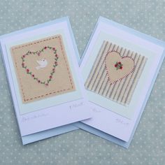 two cards with embroidered hearts on them, one has a bird and the other has a heart