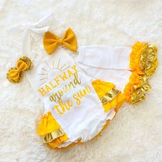 This adorable romper is perfect for your princess' six month birthday outfit. It makes a great photo prop for her six month birthday pictures just to remember this special day!! The romper has straps that untie so you can lower or raise the outfit for a better fit. The back of the romper has layers of ruffle and the top of the ruffles is embellished with  a gold bow. If you would like a different color bow, please message me with the color that you would like.  HEADBANDS- The headband is made to fit the size that is chosen for the romper. If you would like the headband to be a different size please just leave a message on your order with the size that you would like me to make for you.   You have your choice of a bow headband or a rosette headband. I do offer different color bows or rosett Half Way Around The Sun 6 Months Photoshoot, Half Birthday Dress, Half Way Around The Sun 6 Months, Halfway Around The Sun, Half Birthday Outfit, Six Month Birthday, 6 Month Birthday, Sun Outfit, Winter Onederland Birthday Party