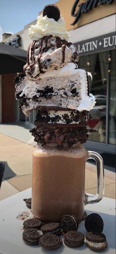 an ice cream sundae is stacked on top of each other with oreo cookies