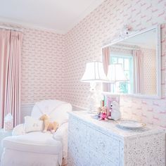 a pink and white girls'bedroom decorated in pastel tones