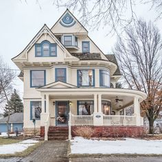 a large white house with blue trim and windows