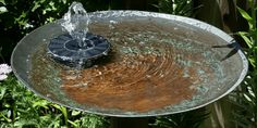 a bird bath with water running from it