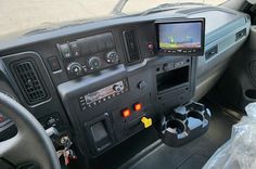 the inside of a vehicle with various controls and dashboards on it's display