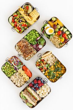 six trays filled with different types of food