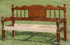 a wooden bench sitting on top of a lush green field