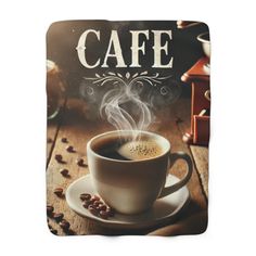 a cup of coffee on a saucer with steam coming out of it and the words cafe written in white