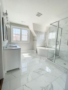 a bathroom with white marble flooring and large shower area next to a sink, toilet and bathtub