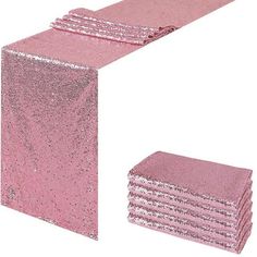 pink sequinized table runner and napkins set on top of each other in front of a white background