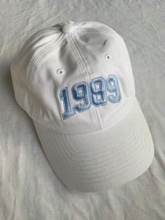 a white baseball cap with the number 991 embroidered on it