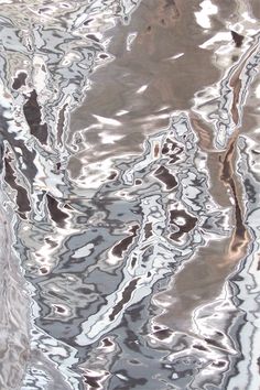 the reflection of trees in water is shown