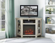 an entertainment center with a fireplace in the corner