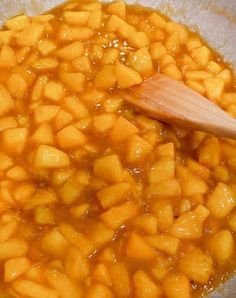 a wooden spoon in a pot filled with food