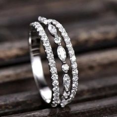 a diamond ring sitting on top of a wooden table