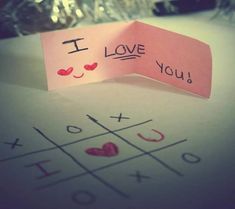 i love you written on a piece of paper next to a tic - tac - toe