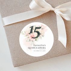 a gift wrapped in brown paper with a white ribbon on it and the number five