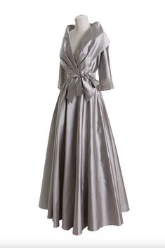 a silver dress with a bow on the waist