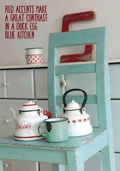 an old chair with two tea kettles on it and the words red accents make a great contrast to blue kitchen color scheme