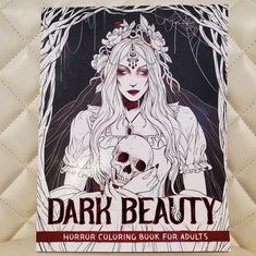 a book with an image of a woman holding a skull in her hands and the title dark beauty