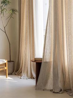 a living room with curtains and a table